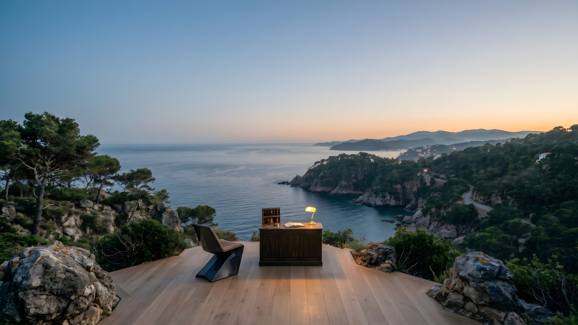 Escritorio y lámpara sobre una terraza de madera frente a la costa al anochecer